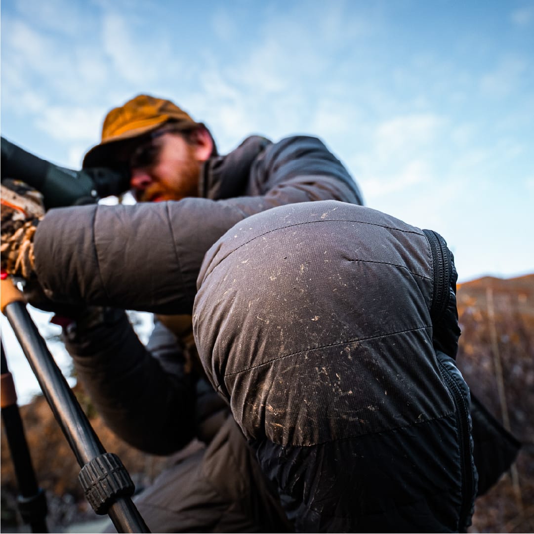 Frost on the knee of the STATIC down pant as a hunter glasses through a spotting scope