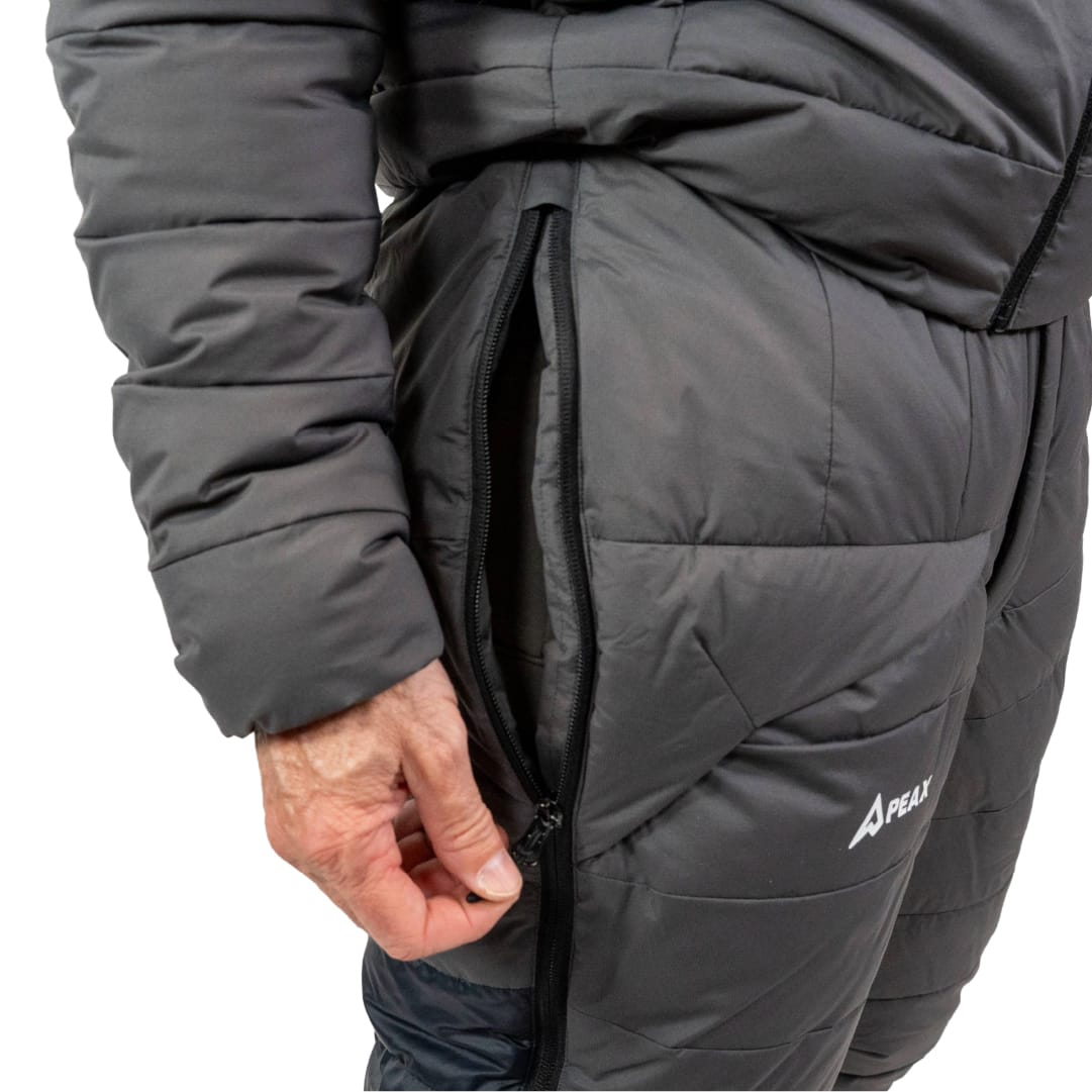 Hand opening the side vent zipper at the hip of the STATIC pant